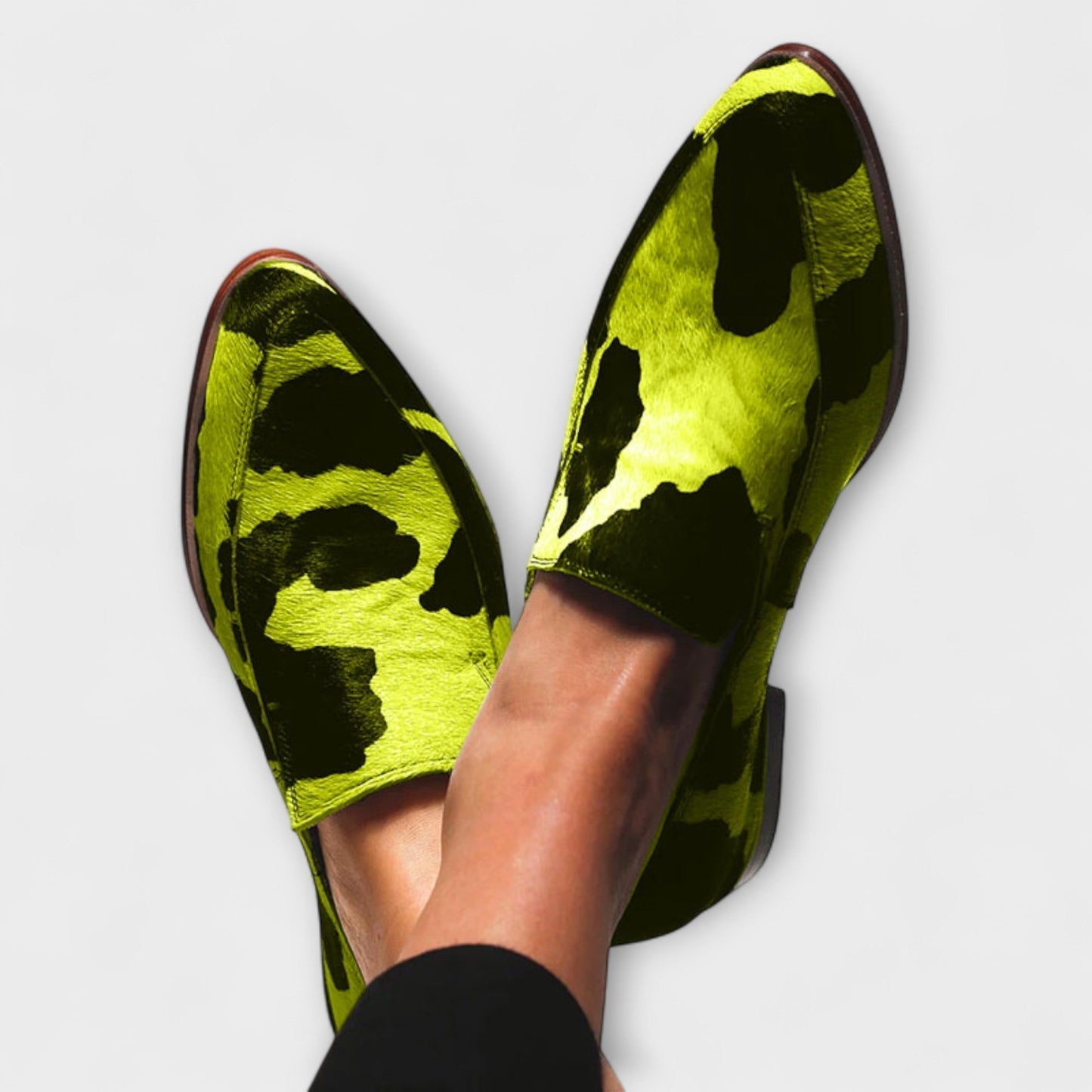 Paloma Women’s loafers featuring a stylish cow print design and elegant pointed toe, perfect for a chic and trendy look. 1