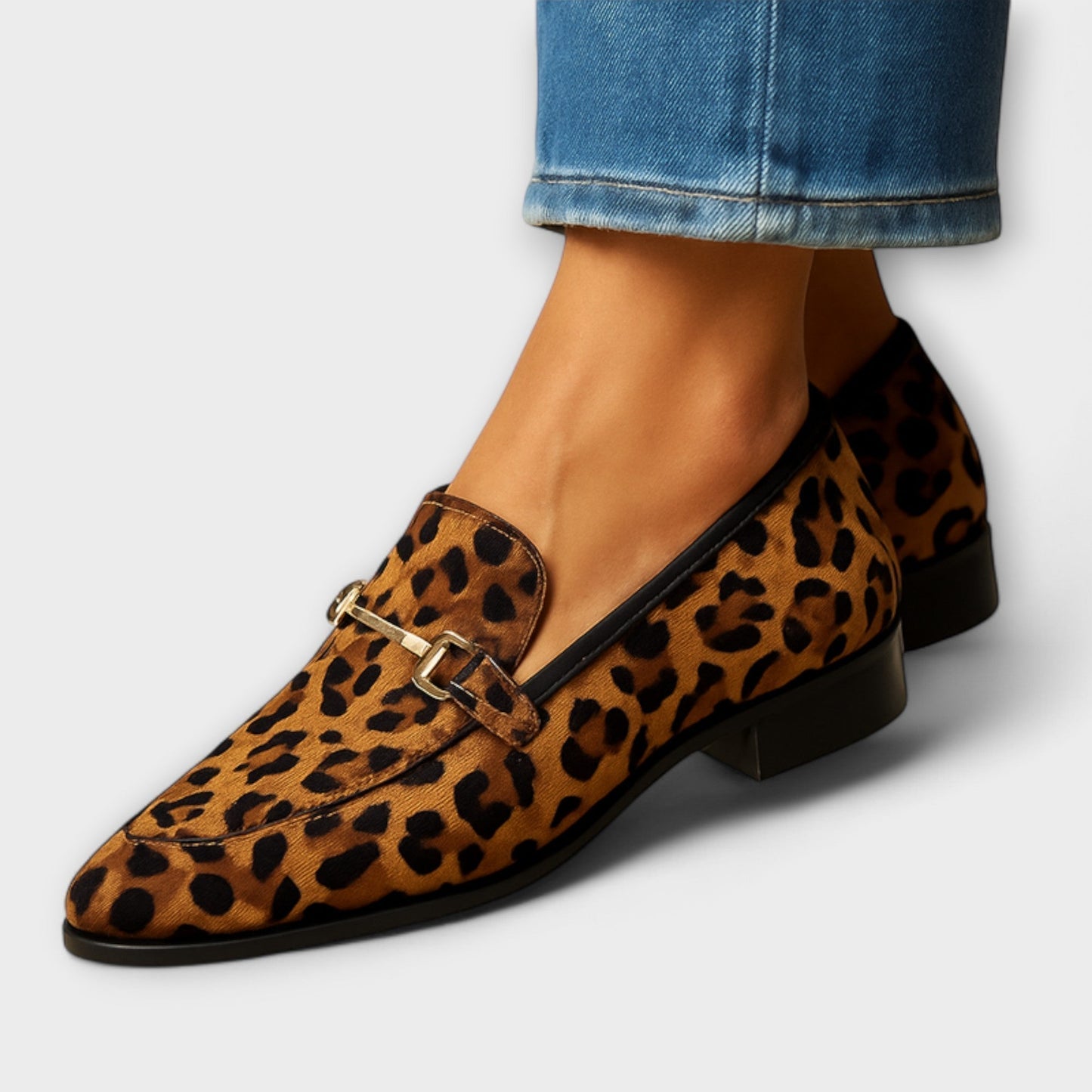 Rita women’s leopard print loafers featuring a pointed toe and stylish metallic buckle detail for a chic and trendy look. 0
