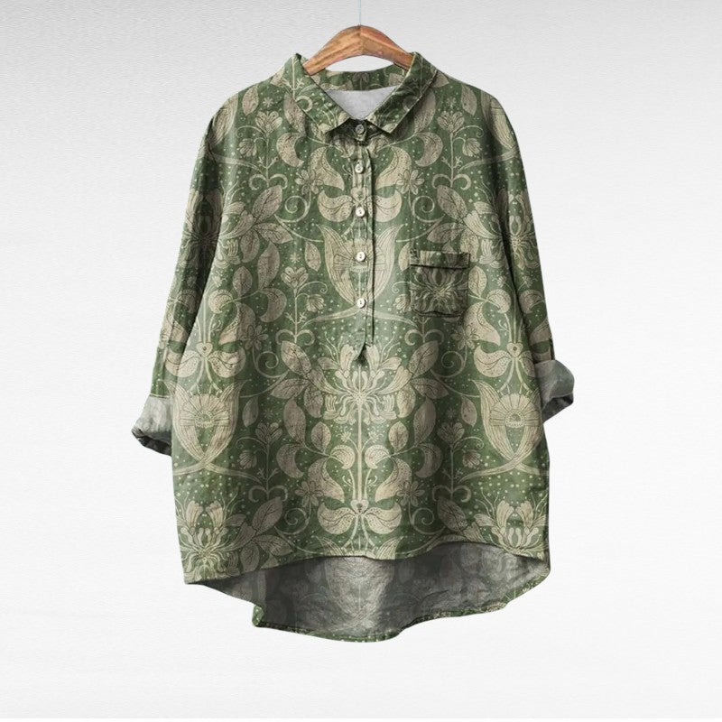 Adira Women’s Blouse featuring a vibrant floral pattern and convenient pocket detail, perfect for casual or semi-formal occasions. 1