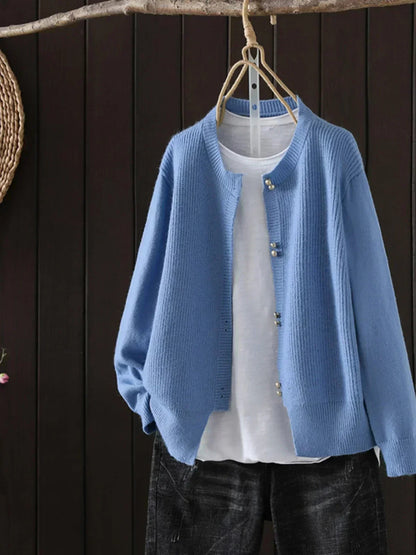 Auri Women’s Cardigan featuring elegant pearl-inspired buttons and a relaxed fit, perfect for stylish layering in any season. 1