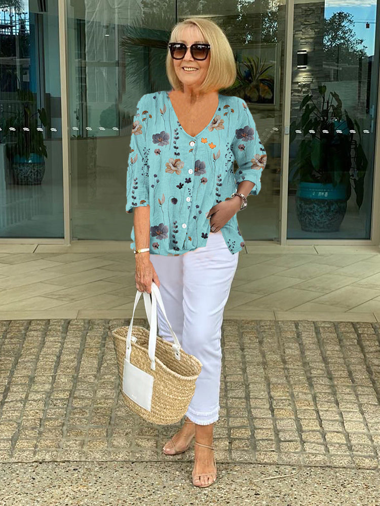 Bella Women’s Blouse featuring a stylish V-neckline and three-quarter sleeves, designed with a vibrant all-over print for a chic and fashionable look. 0