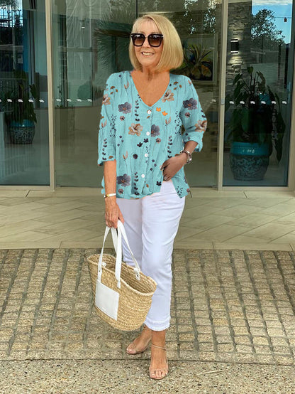 Bella Women’s Blouse featuring a stylish V-neckline and three-quarter sleeves, designed with a vibrant all-over print for a chic and fashionable look. 0