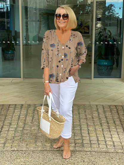 Bella Women’s Blouse featuring a stylish V-neckline and three-quarter sleeves, designed with a vibrant all-over print for a chic and fashionable look. 1