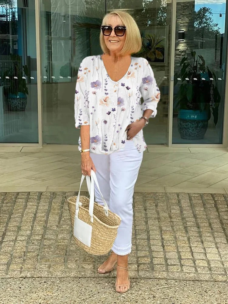 Bella Women’s Blouse featuring a stylish V-neckline and three-quarter sleeves, designed with a vibrant all-over print for a chic and fashionable look. 2