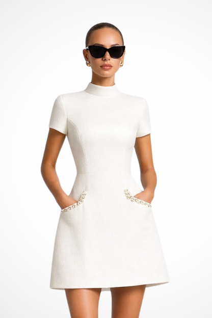 Elegant Bella Women’s Dress featuring stylish pearl-trimmed pockets and short sleeves, perfect for casual outings or special occasions. 1