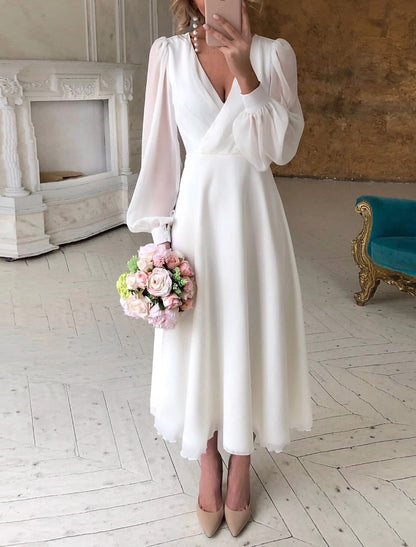 Elegant Bella Women's Wedding Dress featuring classic long sleeves and a flowing design, perfect for brides seeking timeless beauty on their special day. 0