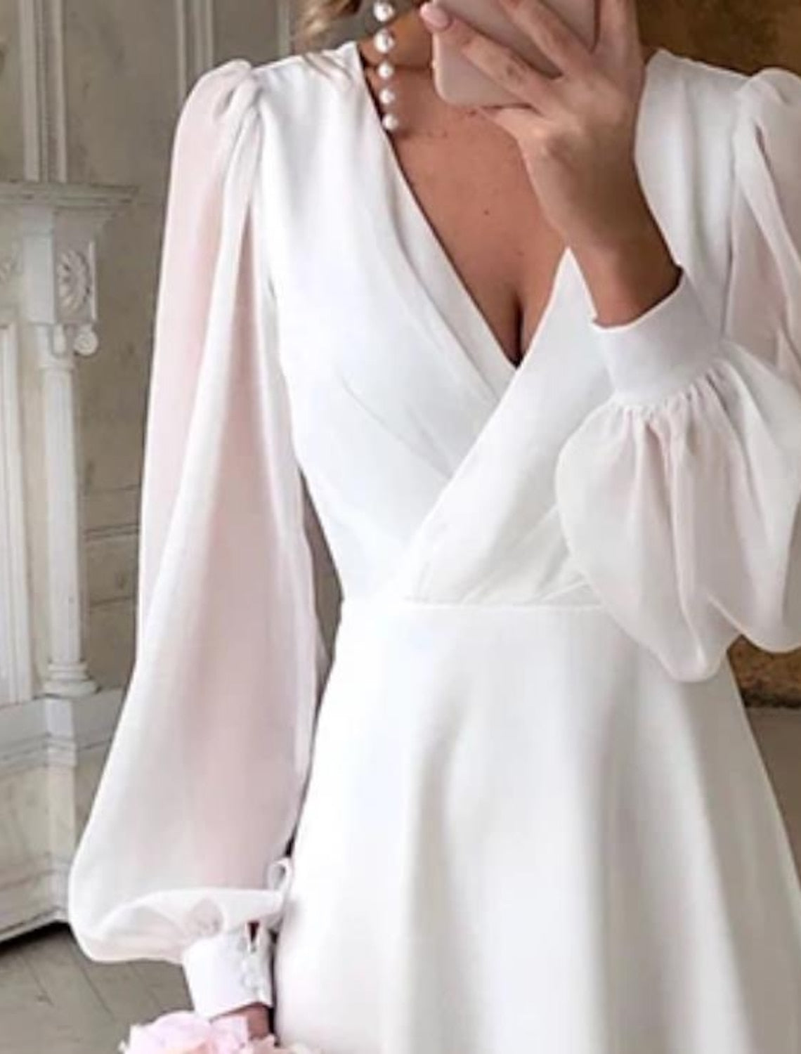 Elegant Bella Women's Wedding Dress featuring classic long sleeves and a flowing design, perfect for brides seeking timeless beauty on their special day. 1