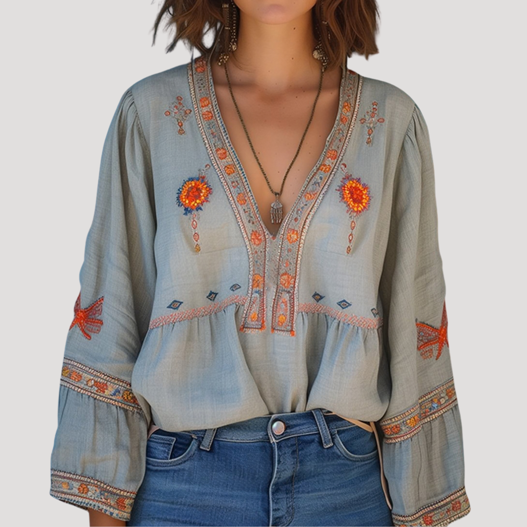 Breezy blouse featuring intricate floral embroidery and a stylish V-neck design, perfect for a casual yet elegant look. 0