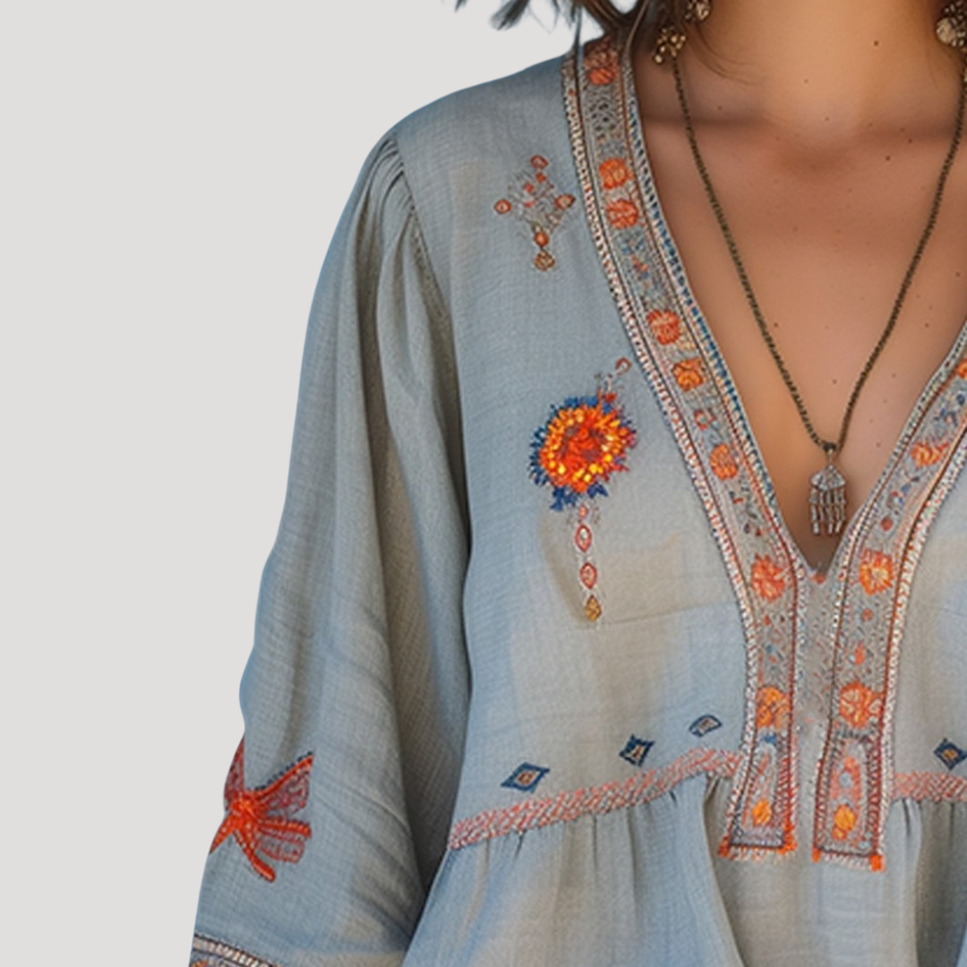 Breezy blouse featuring intricate floral embroidery and a stylish V-neck design, perfect for a casual yet elegant look. 2