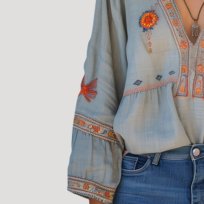 Breezy blouse featuring intricate floral embroidery and a stylish V-neck design, perfect for a casual yet elegant look. 3