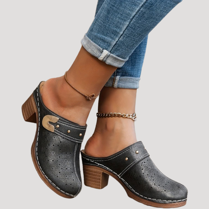 Chic women’s clogs featuring an embossed floral design in a slip-on mule style, perfect for comfortable and stylish everyday wear. 0
