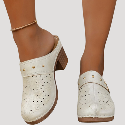 Chic women’s clogs featuring an embossed floral design in a slip-on mule style, perfect for comfortable and stylish everyday wear. 1