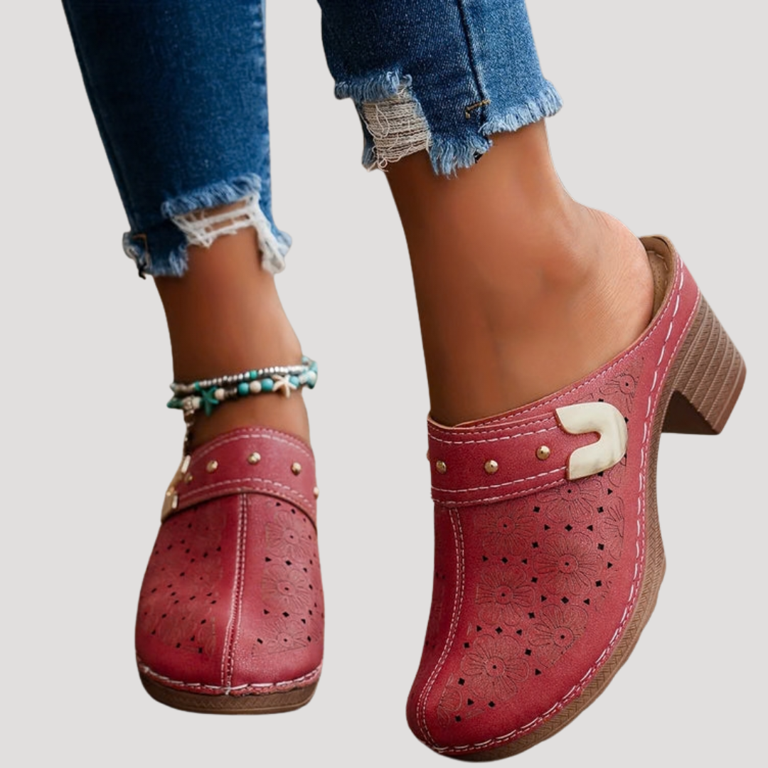 Chic women’s clogs featuring an embossed floral design in a slip-on mule style, perfect for comfortable and stylish everyday wear. 2