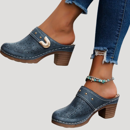 Chic women’s clogs featuring an embossed floral design in a slip-on mule style, perfect for comfortable and stylish everyday wear. 3