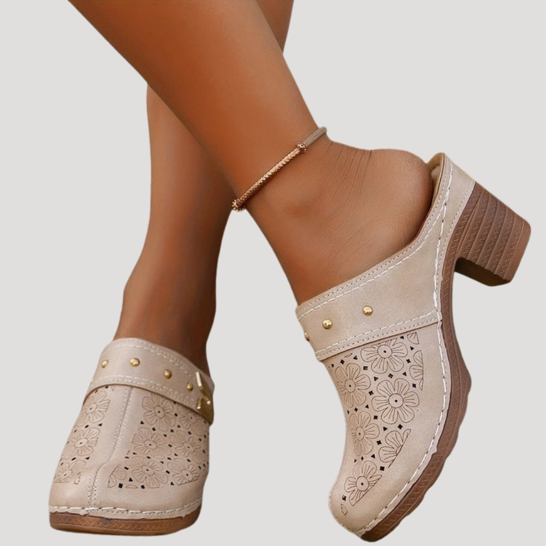 Chic women’s clogs featuring an embossed floral design in a slip-on mule style, perfect for comfortable and stylish everyday wear. 4