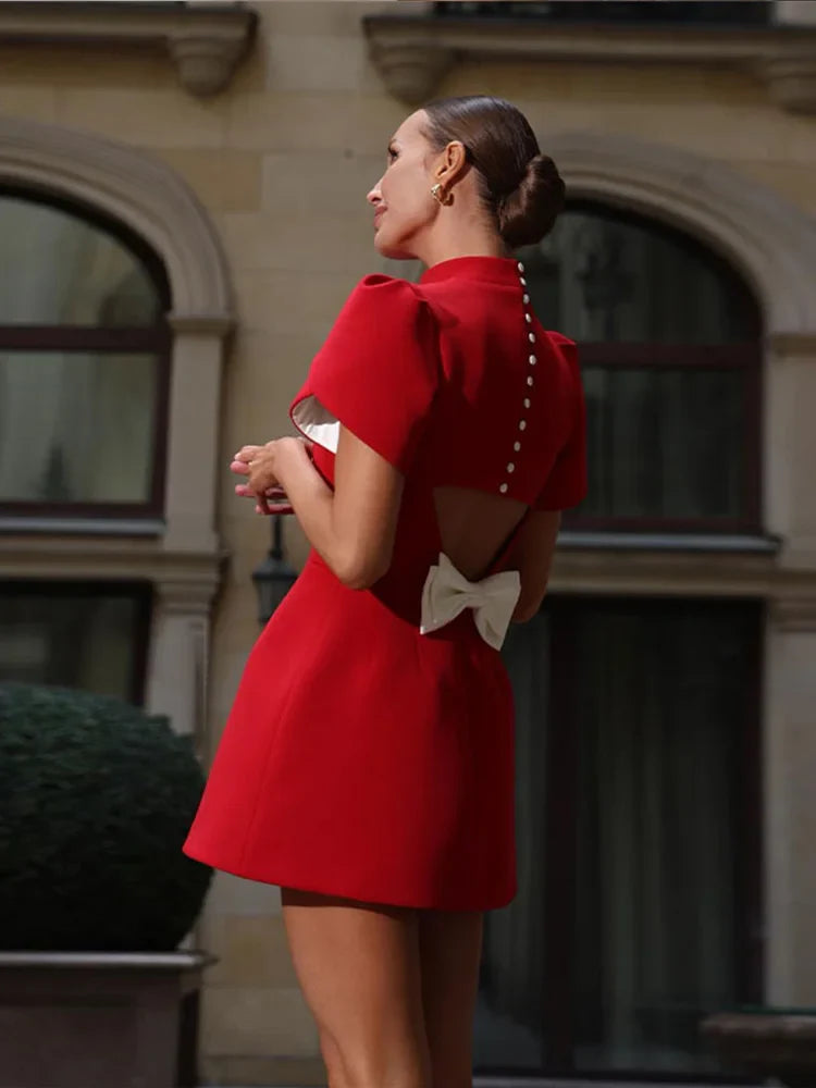 Chic women’s mini dress featuring padded shoulders and a stylish bow detail, perfect for trendy summer outings and special occasions. 3