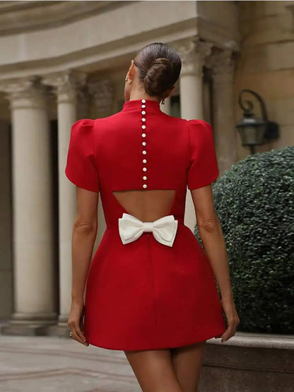 Chic women’s mini dress featuring padded shoulders and a stylish bow detail, perfect for trendy summer outings and special occasions. 5