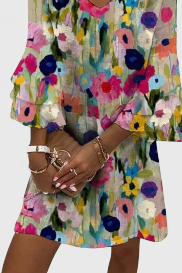 Elysia Women’s Mini Dress featuring a vibrant floral print and stylish V-neckline, perfect for summer outings and casual events. 1