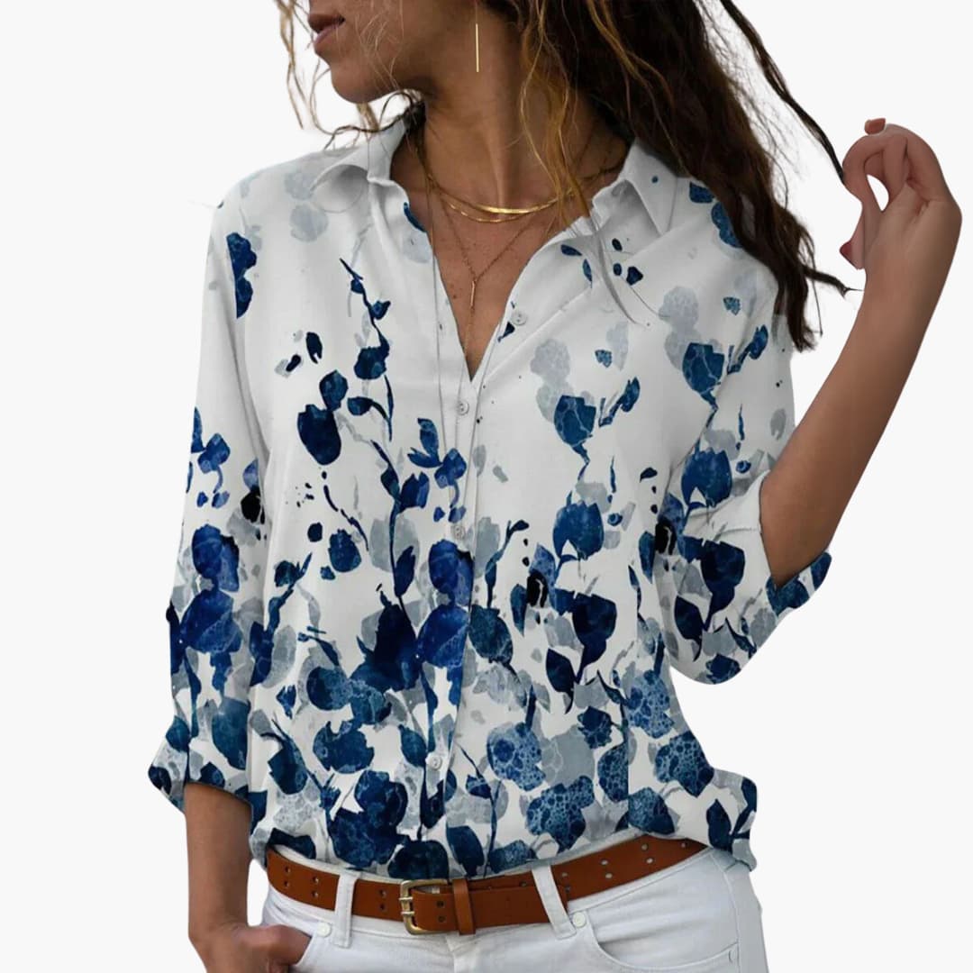 Flora Women’s Blouse featuring a vibrant colorblock floral design and a flattering cut, perfect for stylish casual wear. 1