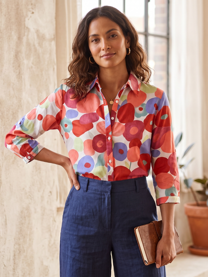 Flora Women’s Blouse featuring a vibrant floral design, long sleeves with roll-tabs, perfect for casual or office wear. 2