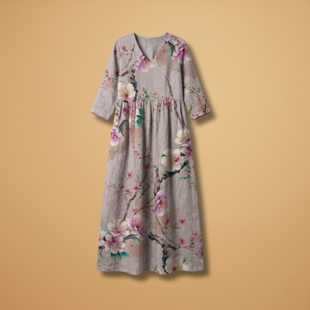 Flora Women’s Dress featuring a V-neck design and a flowing skirt adorned with a vibrant floral pattern, perfect for summer outings and special occasions. 1
