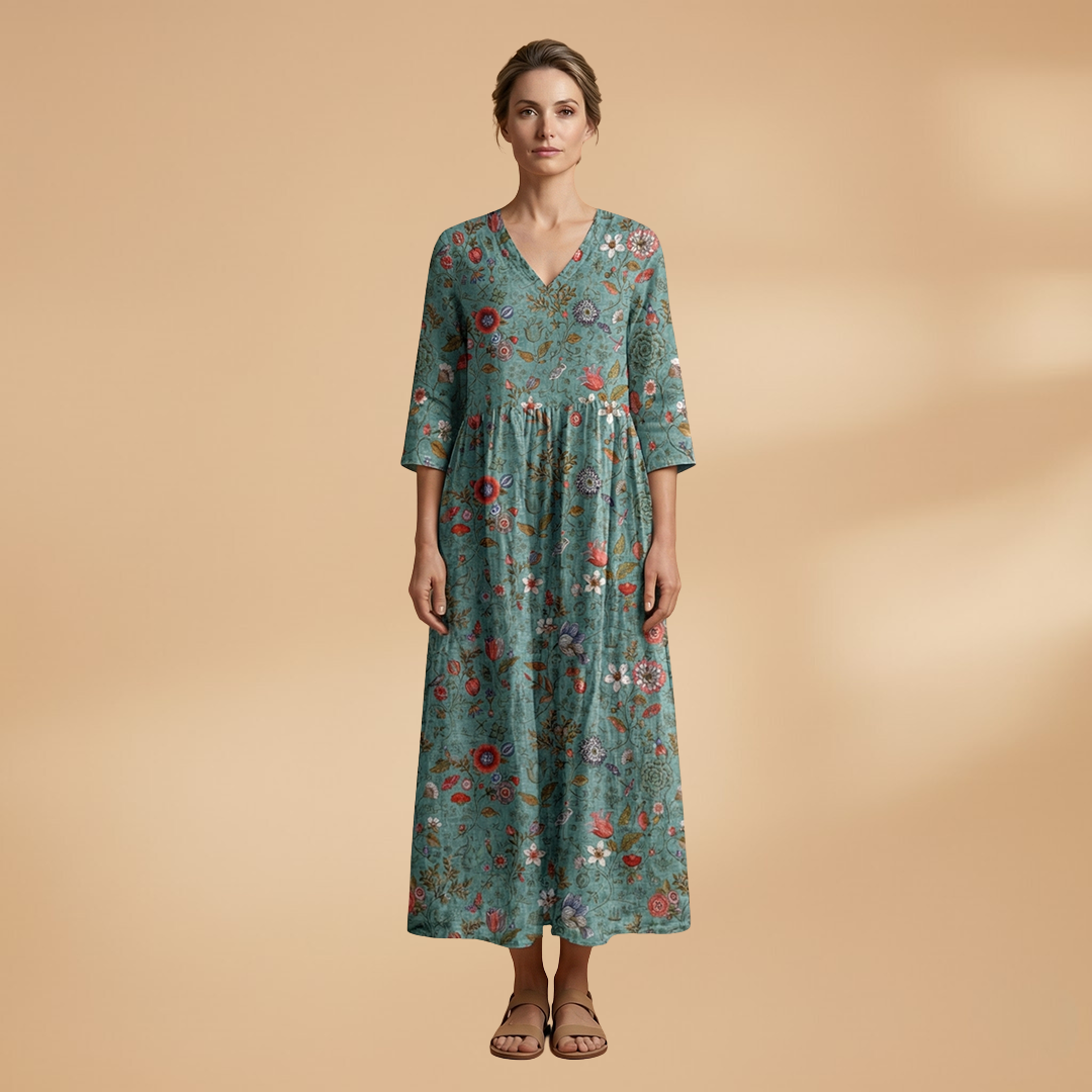 Flora Women’s Dress featuring a V-neck design and a flowing skirt adorned with a vibrant floral pattern, perfect for summer outings and special occasions. 13