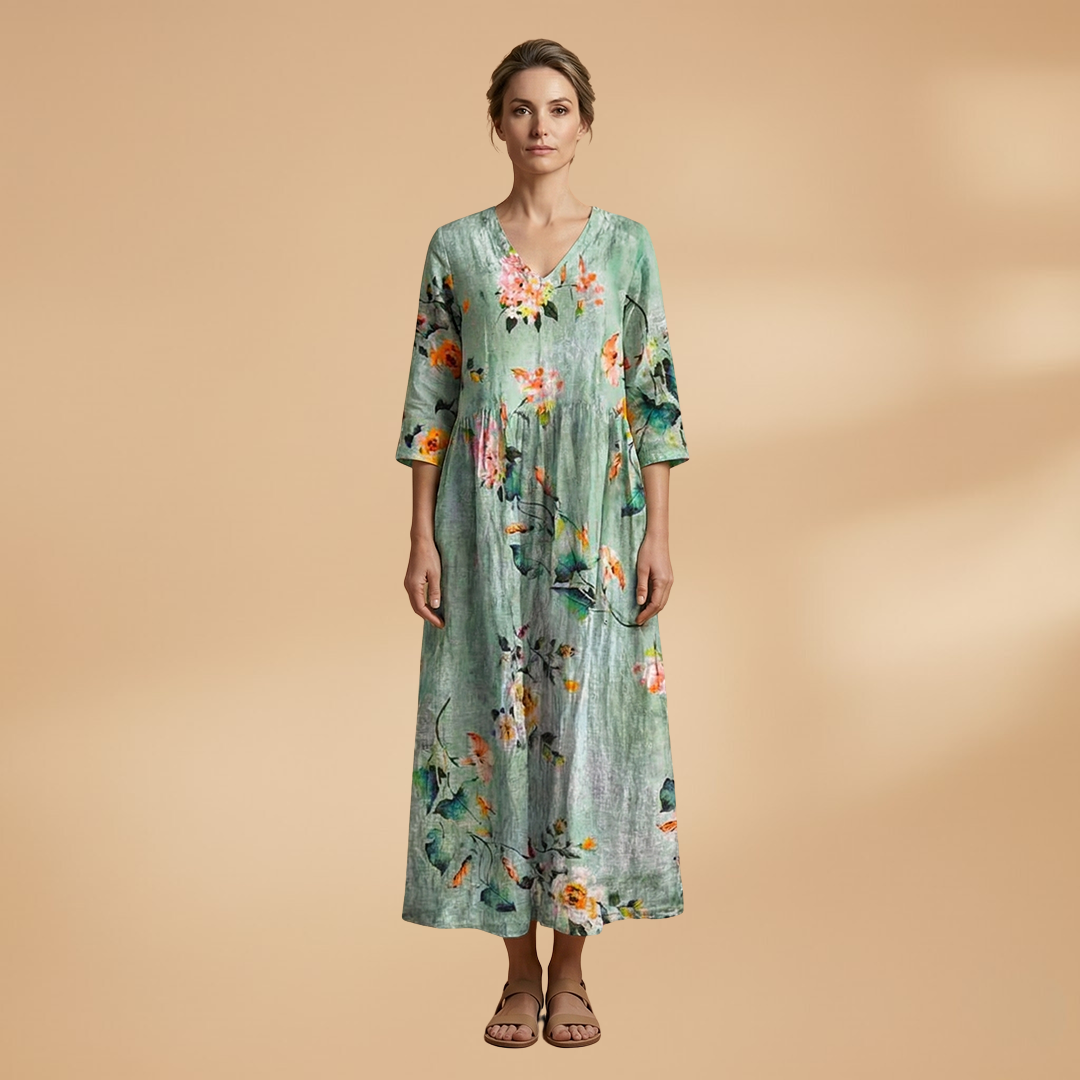 Flora Women’s Dress featuring a V-neck design and a flowing skirt adorned with a vibrant floral pattern, perfect for summer outings and special occasions. 14