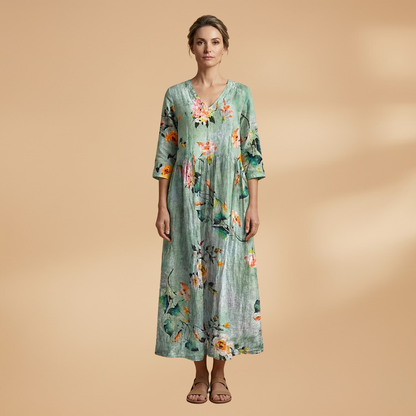Flora Women’s Dress featuring a V-neck design and a flowing skirt adorned with a vibrant floral pattern, perfect for summer outings and special occasions. 14