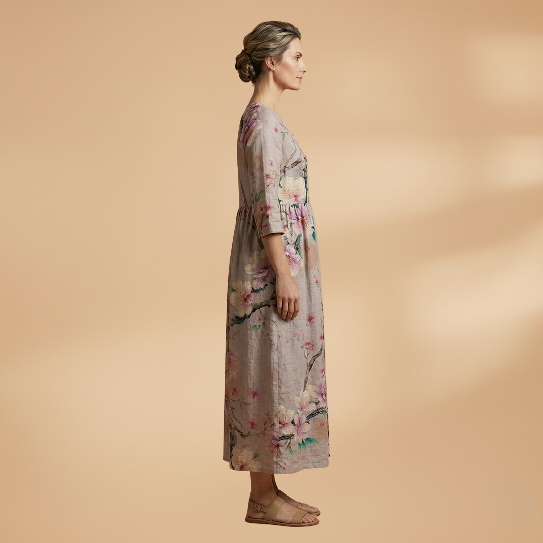 Flora Women’s Dress featuring a V-neck design and a flowing skirt adorned with a vibrant floral pattern, perfect for summer outings and special occasions. 2