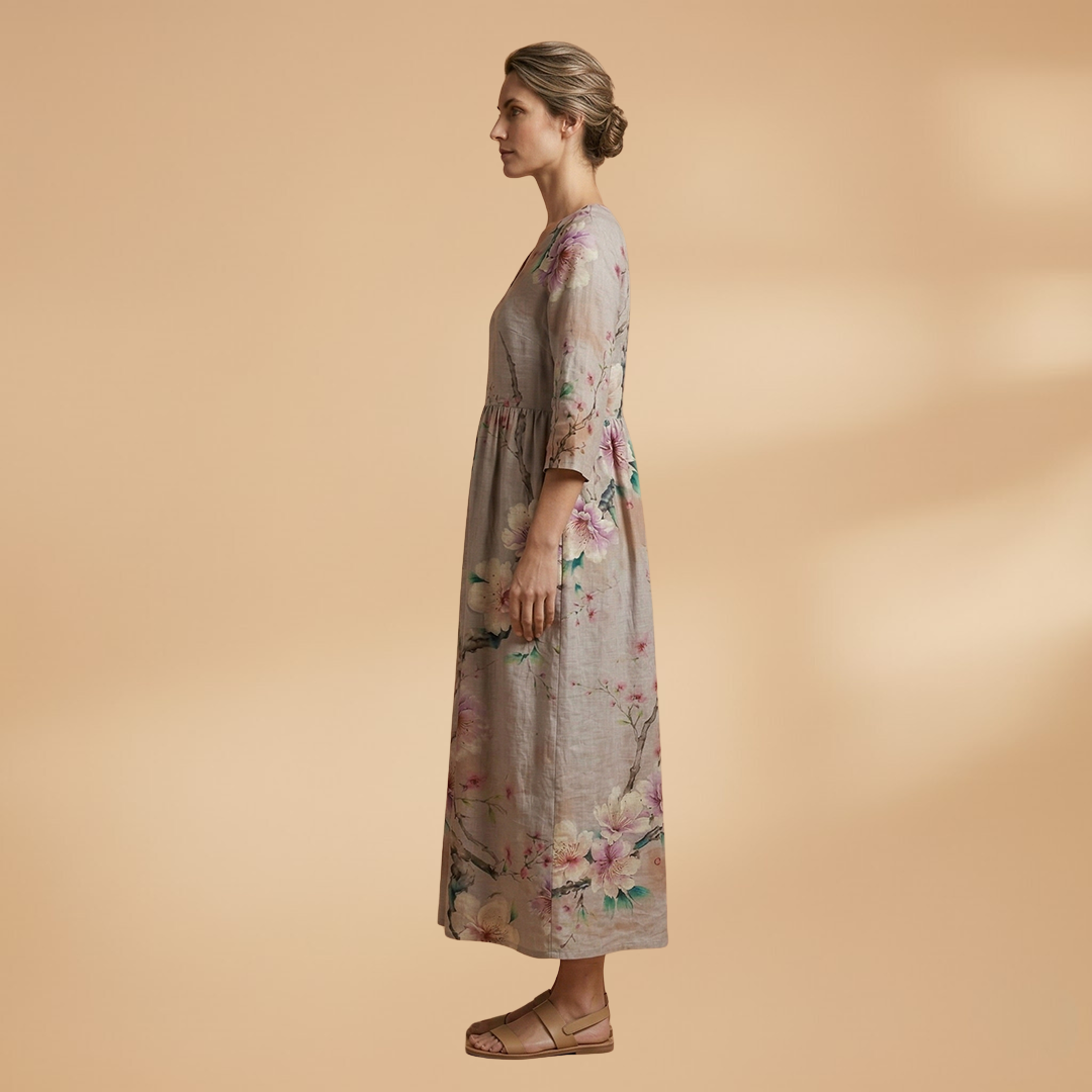 Flora Women’s Dress featuring a V-neck design and a flowing skirt adorned with a vibrant floral pattern, perfect for summer outings and special occasions. 3