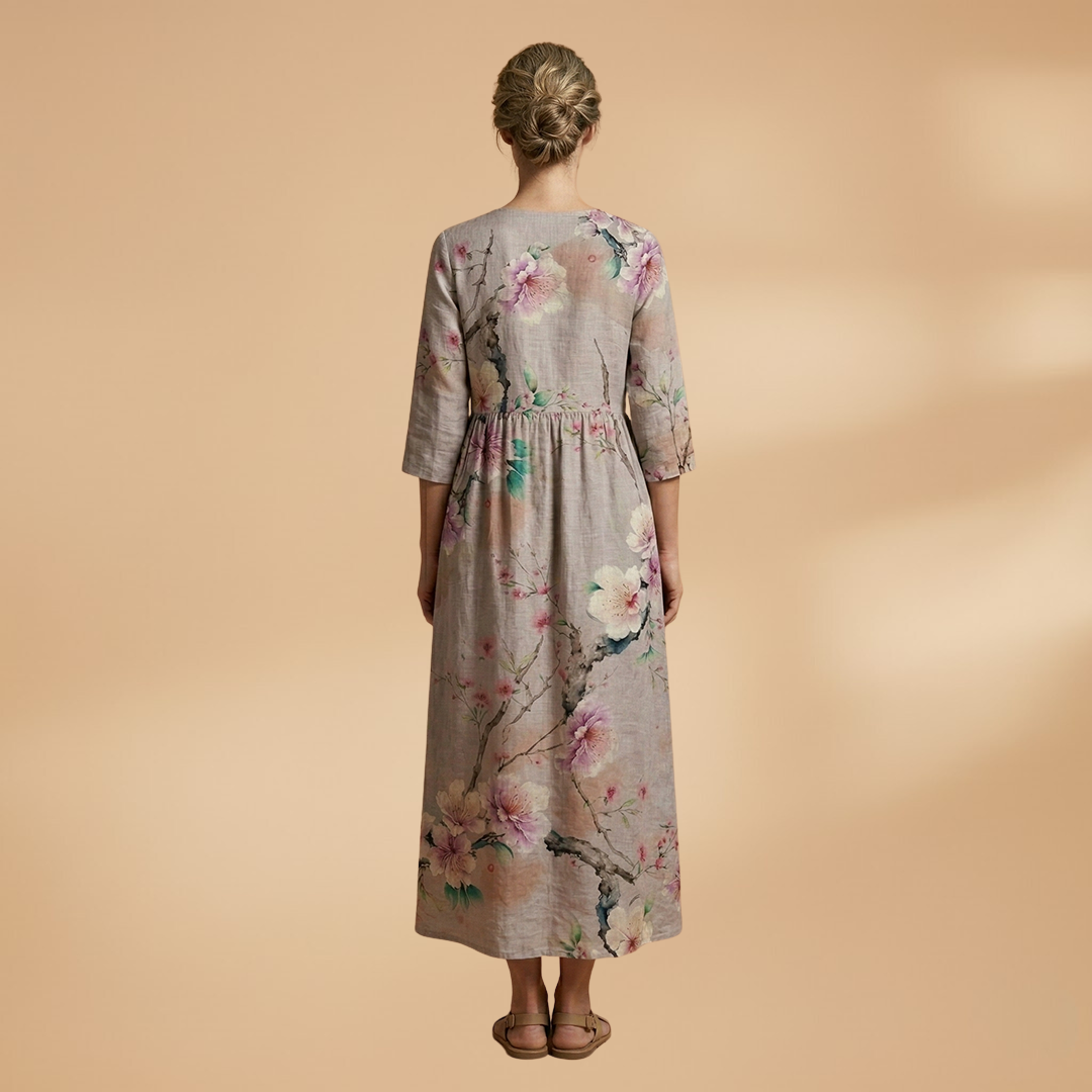 Flora Women’s Dress featuring a V-neck design and a flowing skirt adorned with a vibrant floral pattern, perfect for summer outings and special occasions. 4