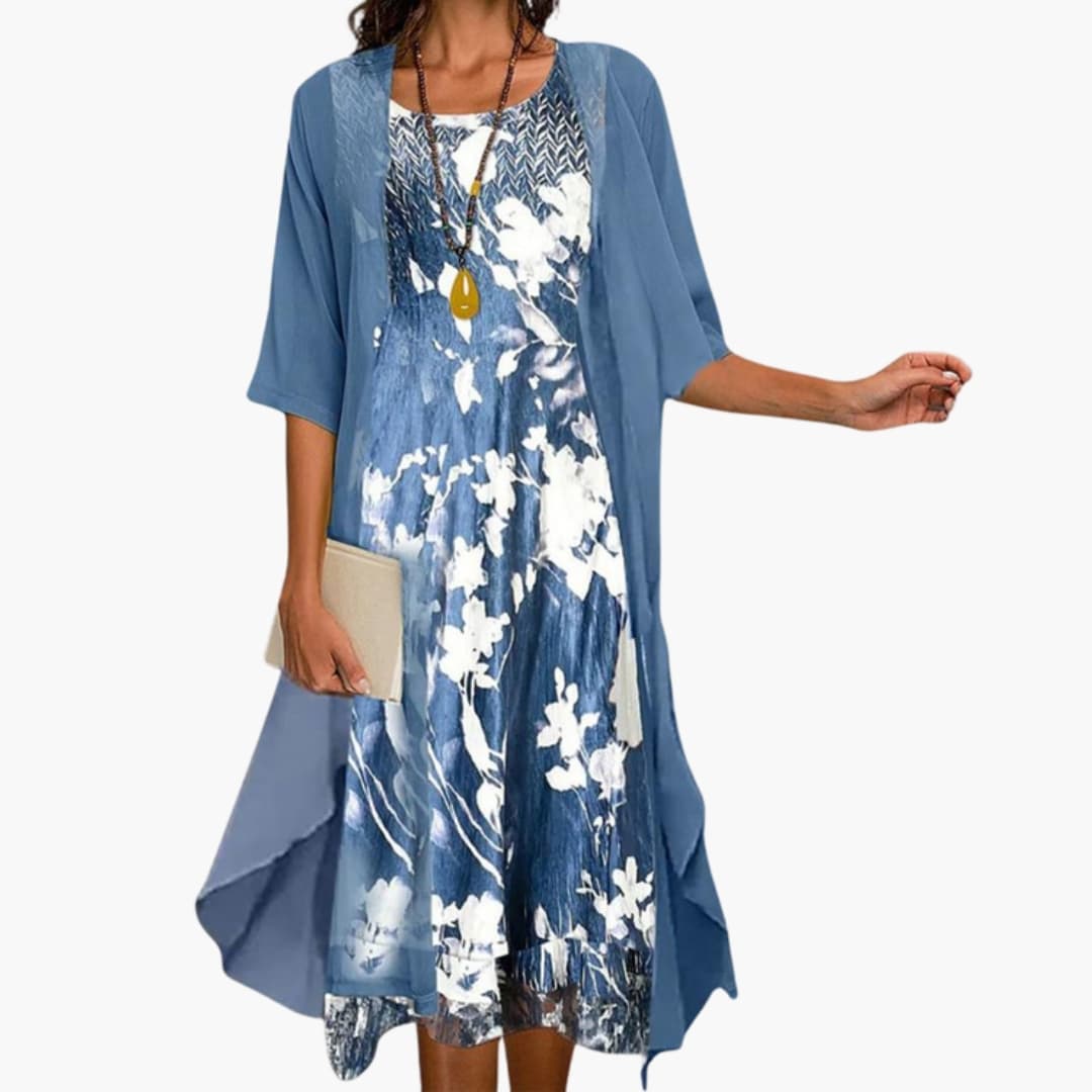 Flora Women’s Maxi Dress featuring a vibrant floral pattern paired with a stylish layered cardigan, perfect for spring and summer outings. 0