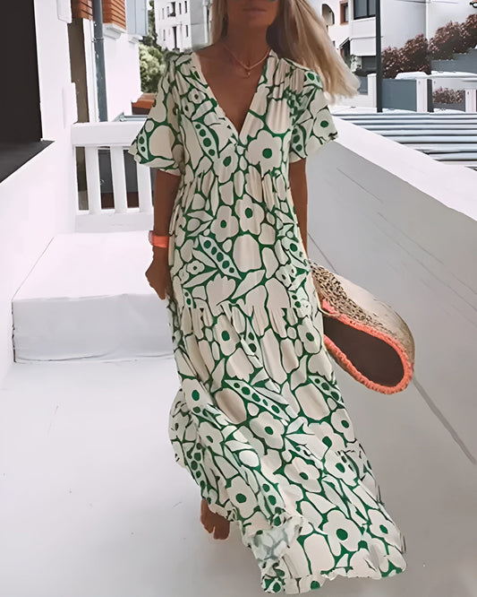 Flora Women’s Maxi Dress featuring a stylish V-Neck and elegant flutter sleeves, designed in a vibrant abstract print perfect for summer outings. 0