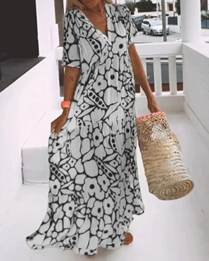 Flora Women’s Maxi Dress featuring a stylish V-Neck and elegant flutter sleeves, designed in a vibrant abstract print perfect for summer outings. 3