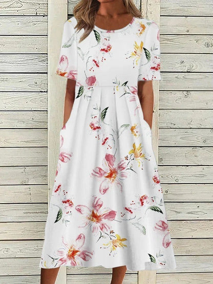 Flora Women’s Midi Dress featuring a vibrant floral print, elegantly designed with functional side pockets for practicality and style. 2