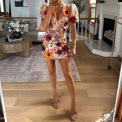 Flora Women’s Mini Dress featuring a vibrant floral print and stylish puff sleeves, perfect for summer events and outdoor gatherings. 3