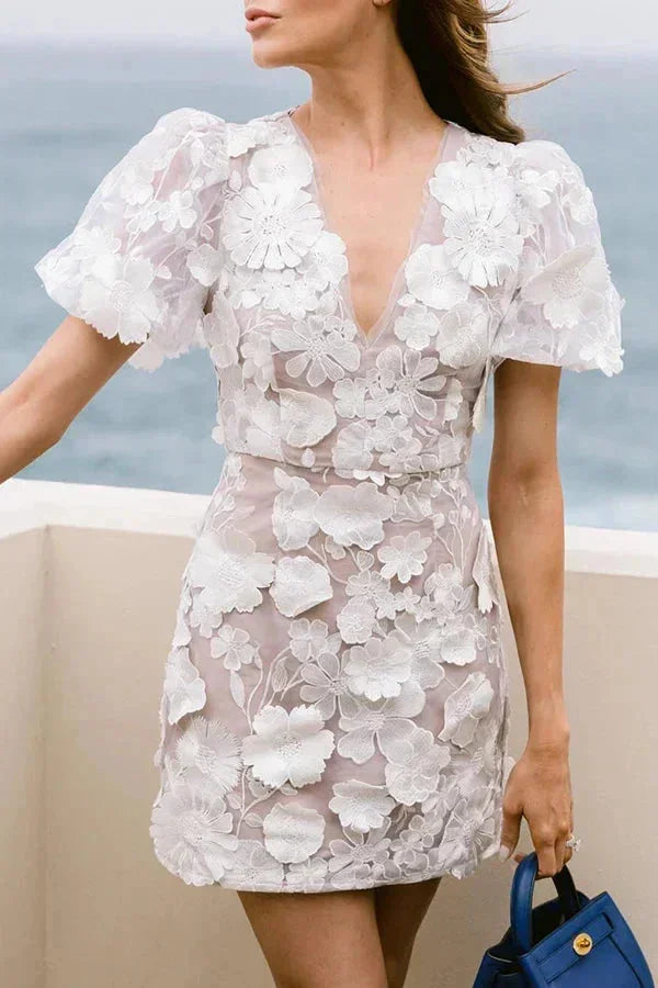 Flora Women’s Mini Dress featuring a vibrant floral print and stylish puff sleeves, perfect for summer events and outdoor gatherings. 4