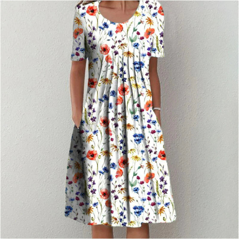 Flora Women’s Summer Dress featuring a vibrant floral print, short sleeves, and convenient side pockets, perfect for warm weather outings. 0