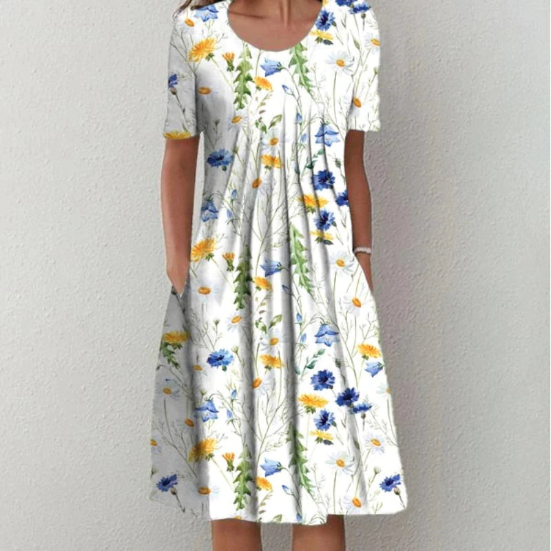 Flora Women’s Summer Dress featuring a vibrant floral print, short sleeves, and convenient side pockets, perfect for warm weather outings. 1