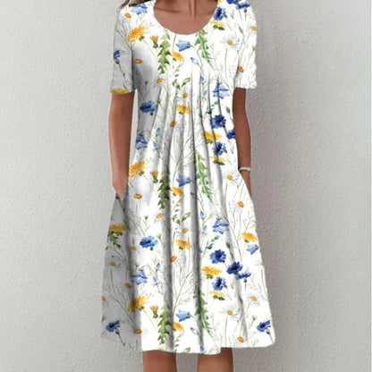 Flora Women’s Summer Dress featuring a vibrant floral print, short sleeves, and convenient side pockets, perfect for warm weather outings. 1