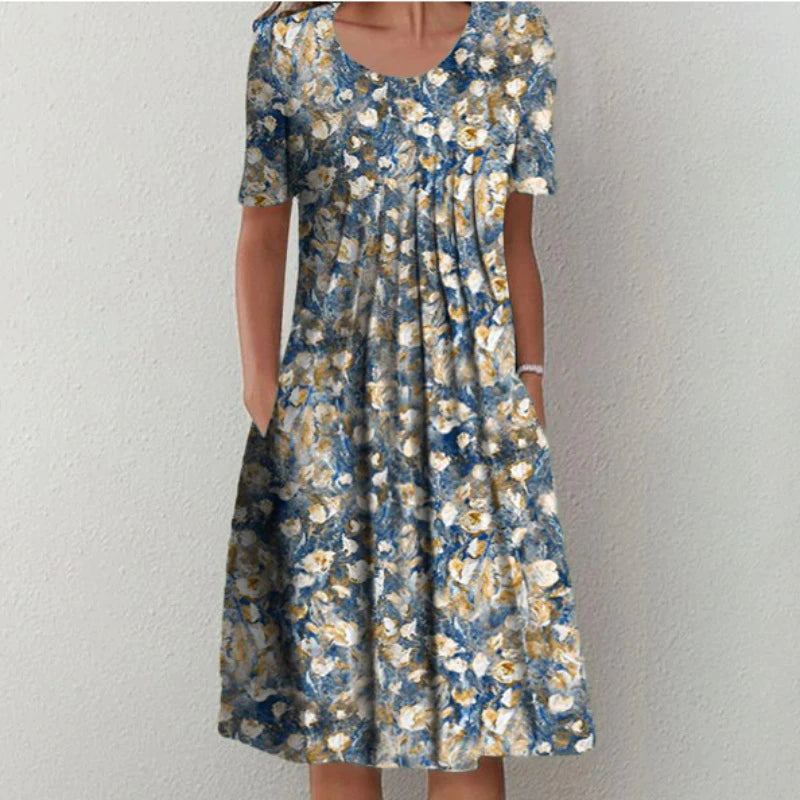 Flora Women’s Summer Dress featuring a vibrant floral print, short sleeves, and convenient side pockets, perfect for warm weather outings. 2