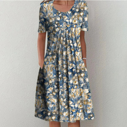 Flora Women’s Summer Dress featuring a vibrant floral print, short sleeves, and convenient side pockets, perfect for warm weather outings. 2