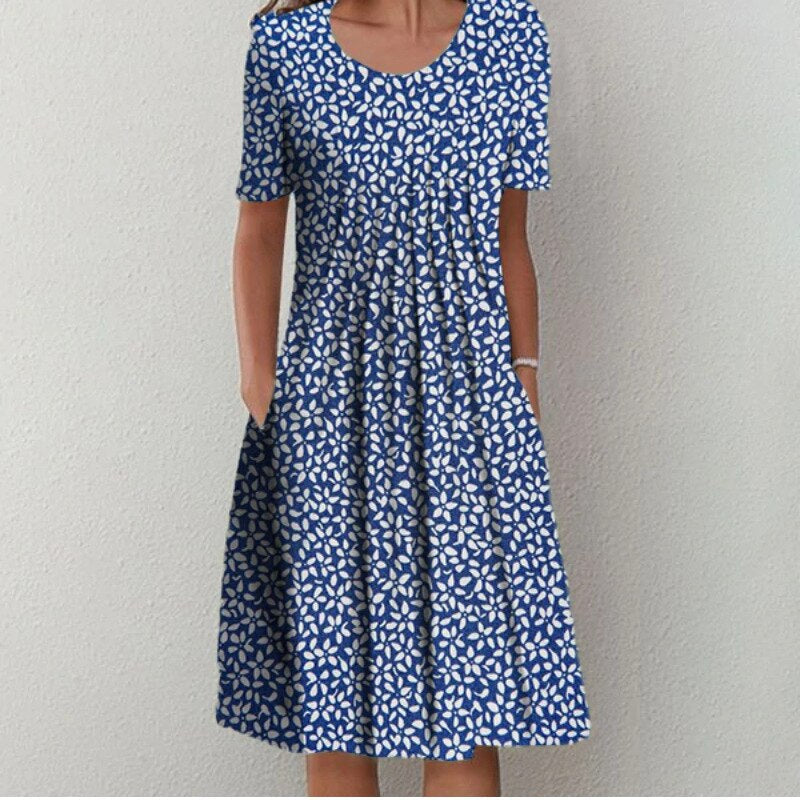 Flora Women’s Summer Dress featuring a vibrant floral print, short sleeves, and convenient side pockets, perfect for warm weather outings. 3
