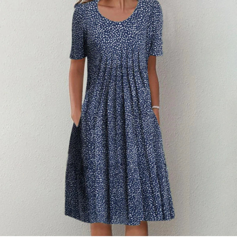 Flora Women’s Summer Dress featuring a vibrant floral print, short sleeves, and convenient side pockets, perfect for warm weather outings. 4