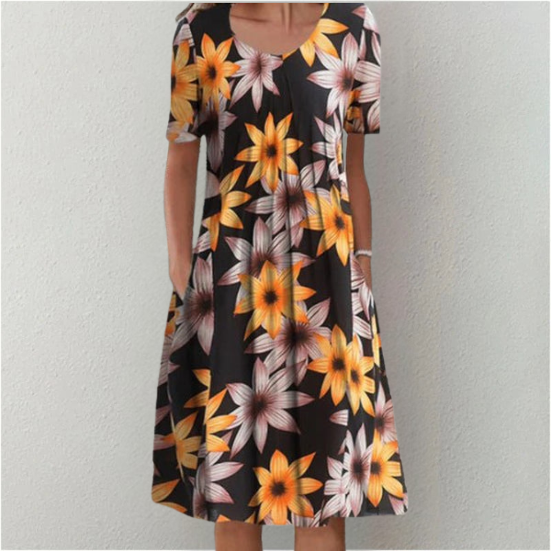 Flora Women’s Summer Dress featuring a vibrant floral print, short sleeves, and convenient side pockets, perfect for warm weather outings. 7