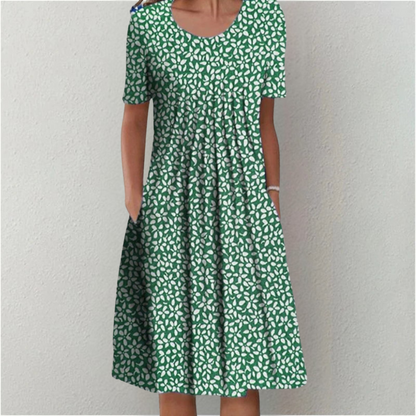 Flora Women’s Summer Dress featuring a vibrant floral print, short sleeves, and convenient side pockets, perfect for warm weather outings. 8