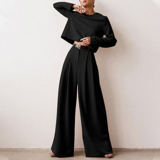 Luxe women’s two-piece outfit featuring a stylish cropped top and elegant wide-leg trousers, perfect for fashionable casual or semi-formal occasions. 0