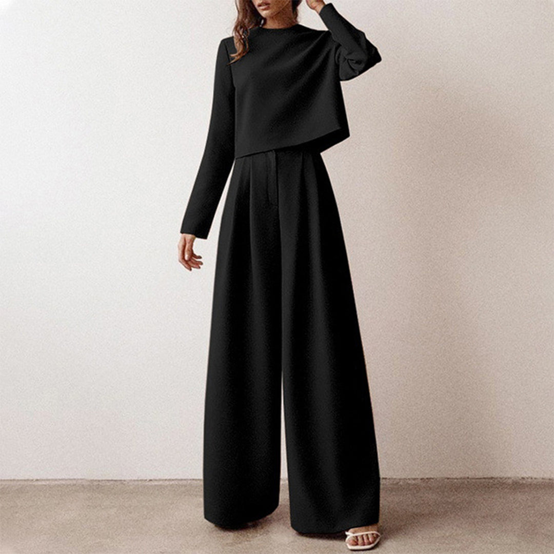 Luxe women’s two-piece outfit featuring a stylish cropped top and elegant wide-leg trousers, perfect for fashionable casual or semi-formal occasions. 1