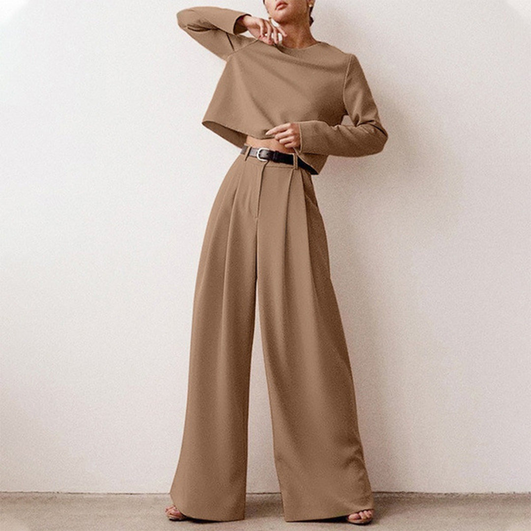 Luxe women’s two-piece outfit featuring a stylish cropped top and elegant wide-leg trousers, perfect for fashionable casual or semi-formal occasions. 7