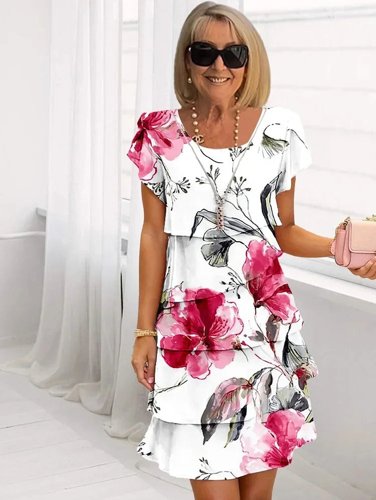 Mira Women’s Dress featuring a ruffled floral design and elegant pleated detail, perfect for spring and summer occasions. 0